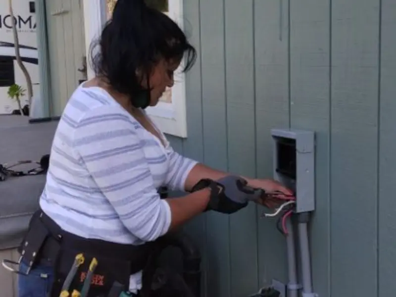 Licensed electrician wiring an exterior subpanel in Independence